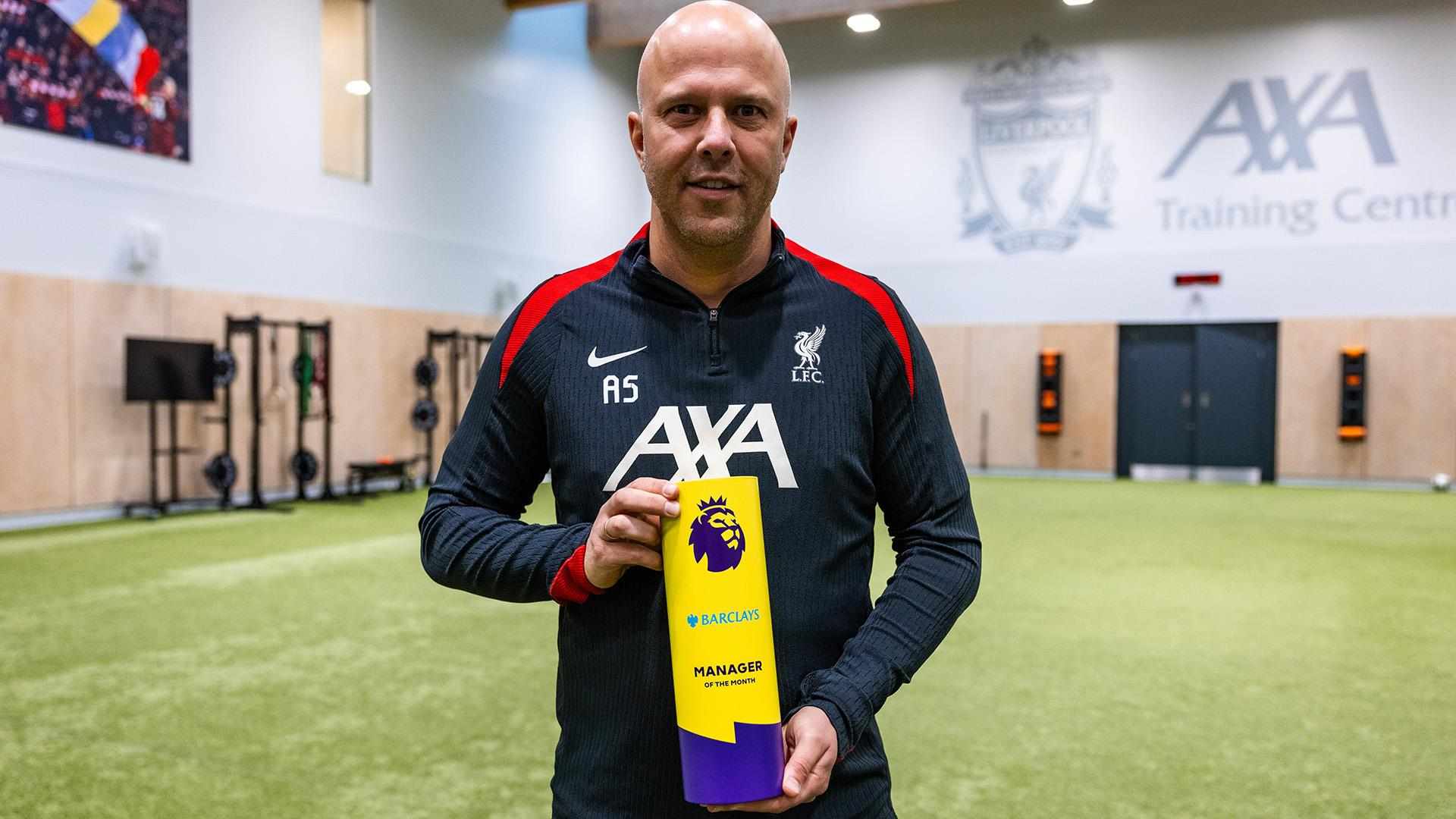 Liverpool's manager Arne Slot posing with the Manager of the Month award for November