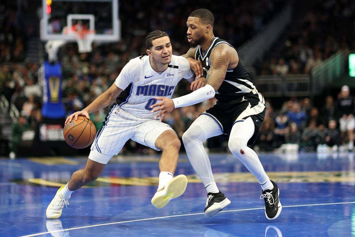 Anthony Black of Orlando Magic against Damian Lillard of the Milwaukee Bucks