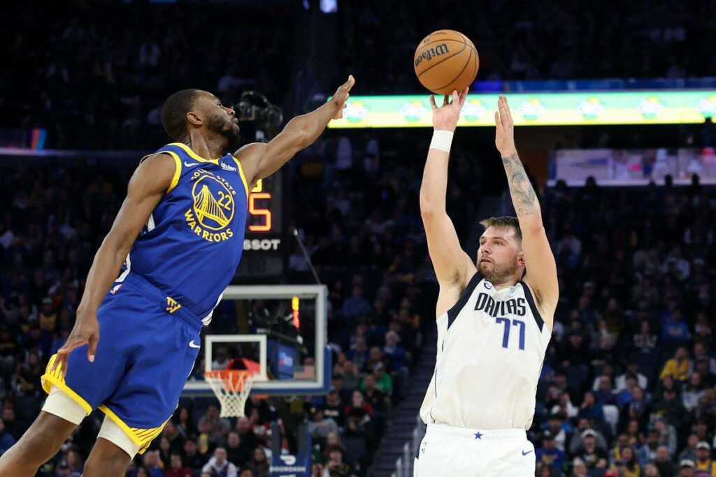 Luka Doncic shoots over Andrew Wiggins in Dallas' win over Golden State