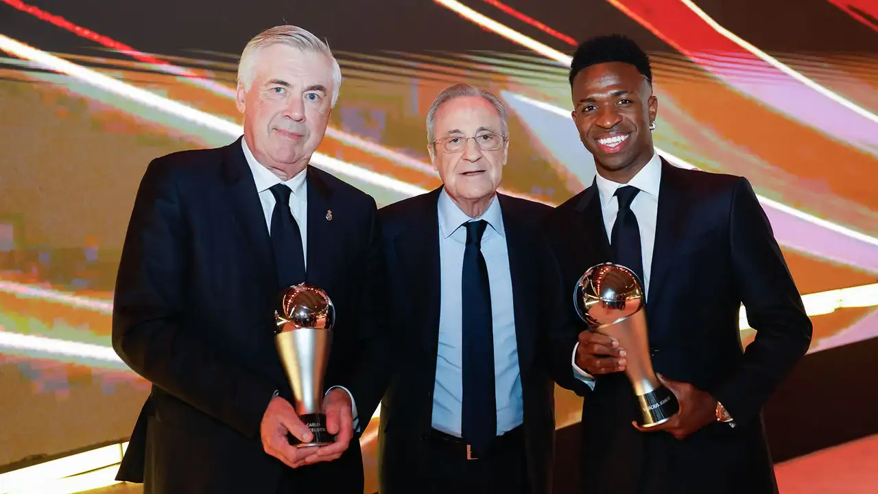 Ancelotti, Perez, and Vinicius Jr. showing their FIFA Best awards