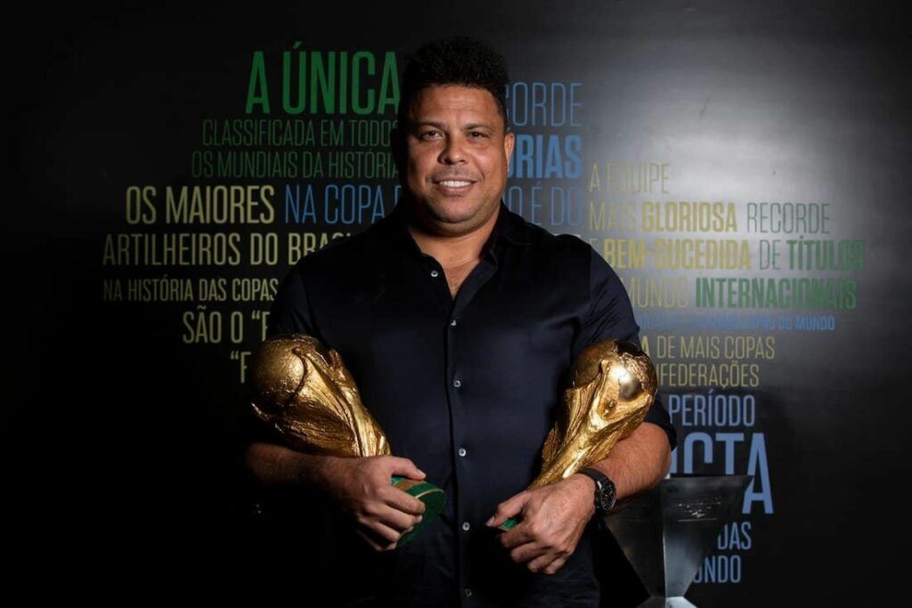 Brazilian legend Ronaldo posing with 2 World Cup trophies