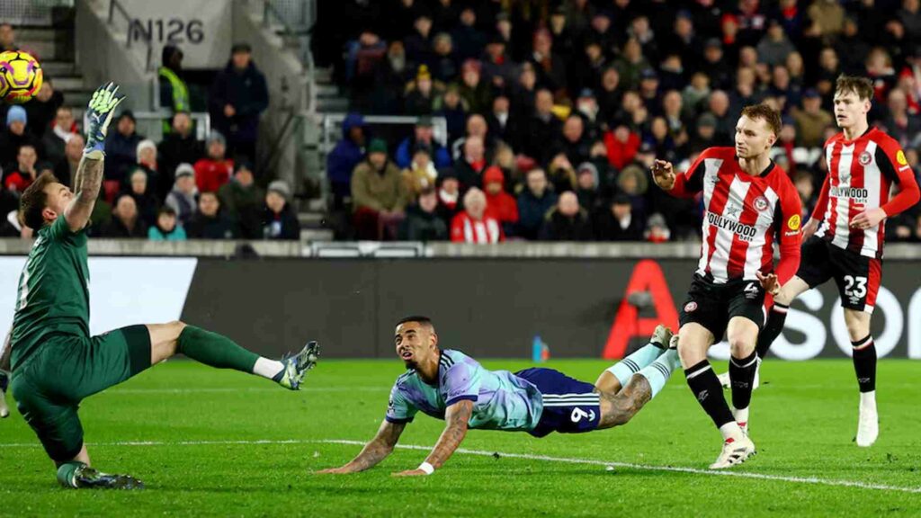 Gabriel Jesus watches as the ball flies towards Mark Flekken's goal