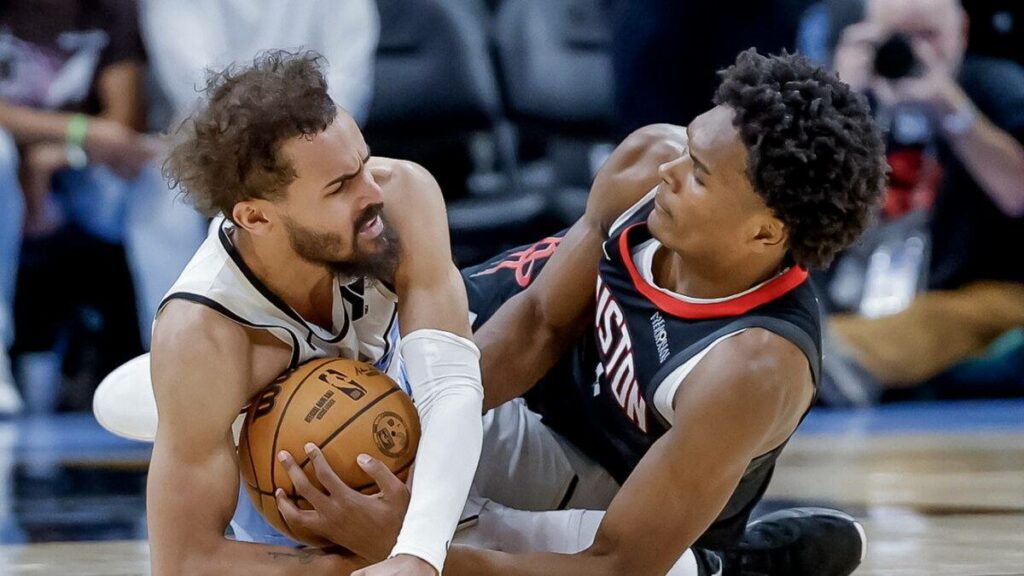 Trae Young and Amen Thompson battling for the ball