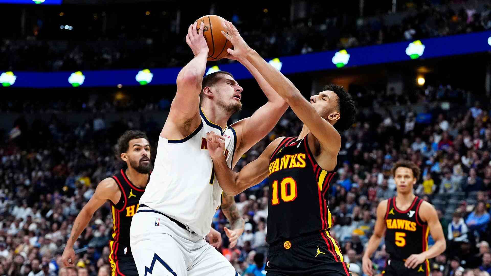 Nikola Jokic battling under the basket with Atlanta players