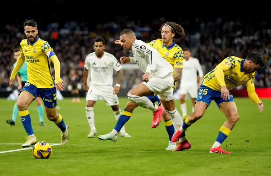 Kylian Mbappe dribbling past multiple Las Palmas players