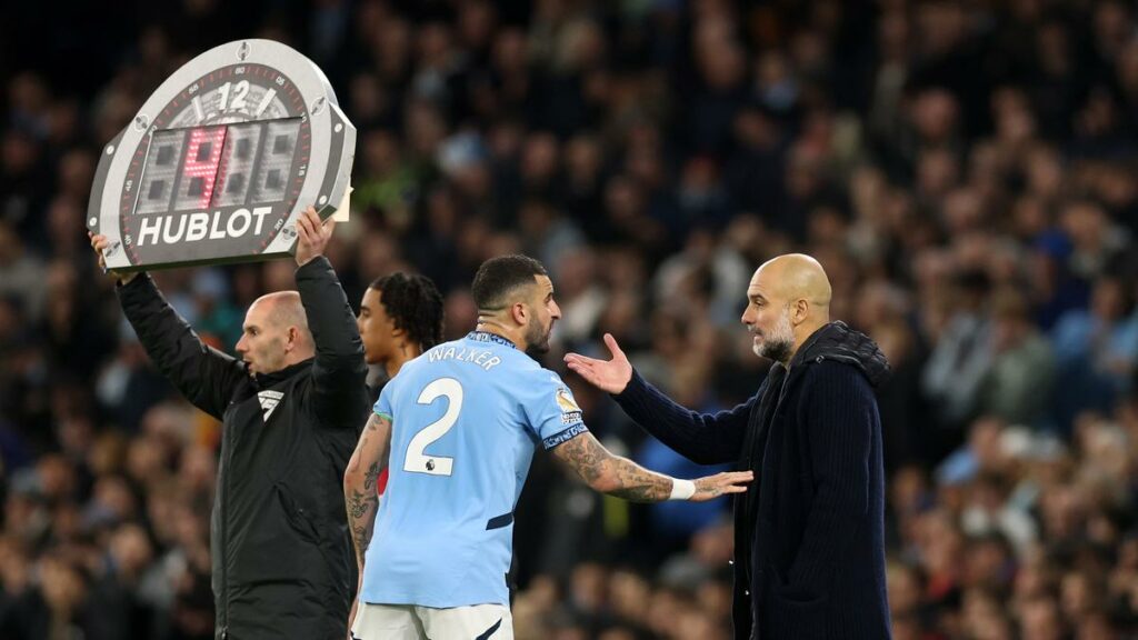 Pep Guardiola giving touchline instructions to Manchester City defender Kyle Walker