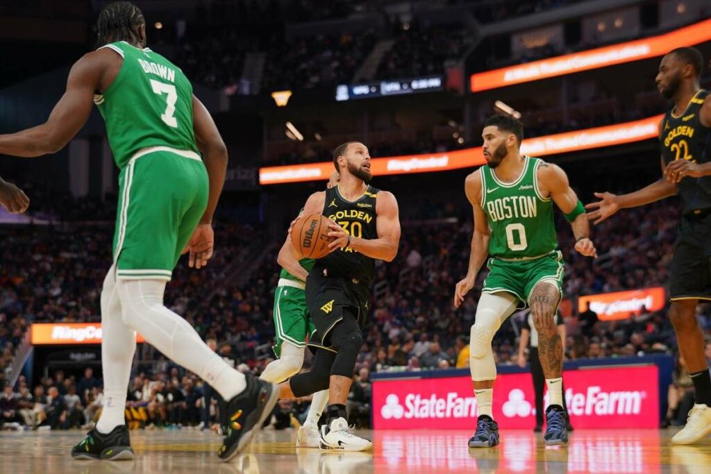 Stephen Curry attacking Boston Celtic's basket