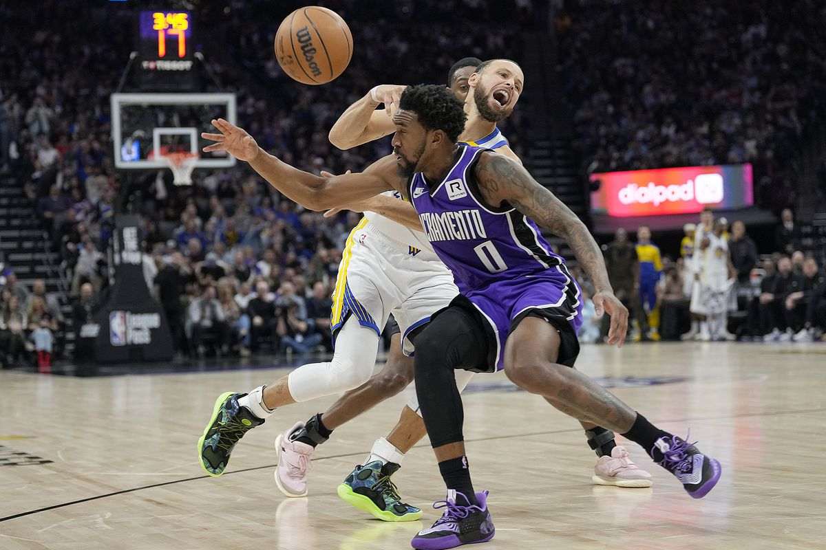 Malik Monk and Stephen Curry battling for the ball