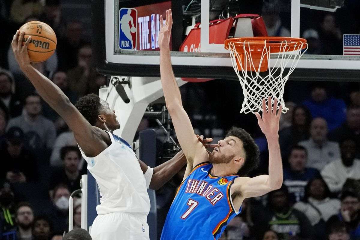 Minnesota's Anthony Edwards attempting a dunk over Chet Holmgren