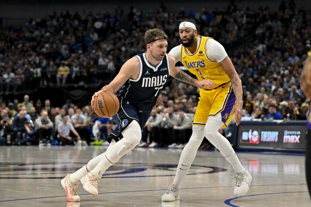 Luka Doncic dribbles, guarded by Anthony Davis