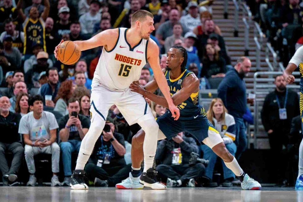 Nikola Jokic with the ball guarded by an Indiana player