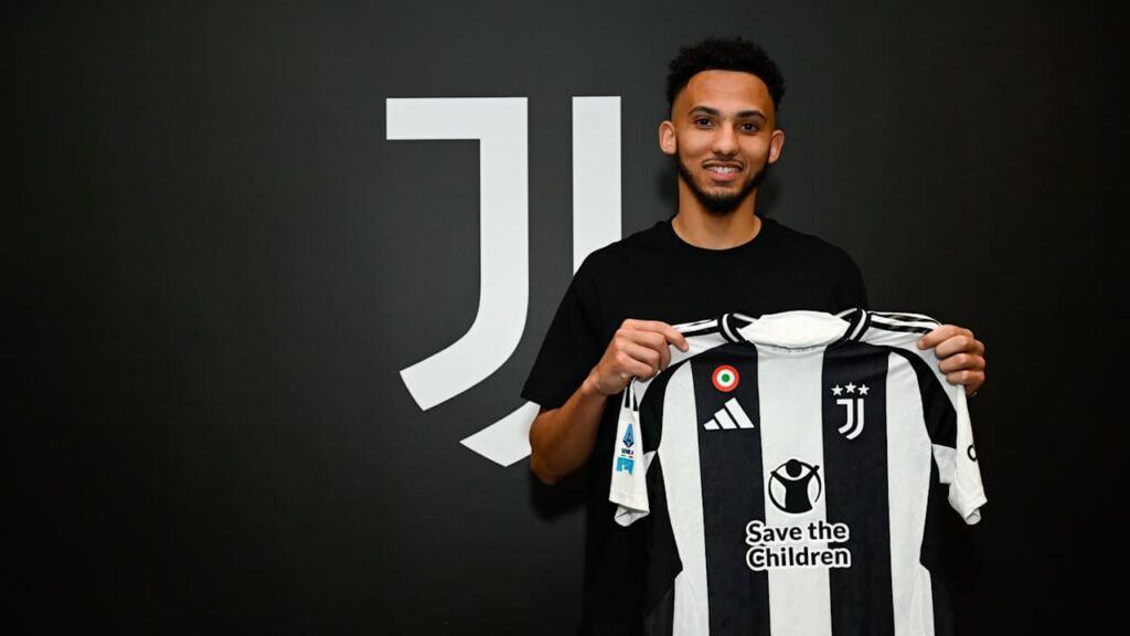 Lloyd Kelly posing with Juventus shirt