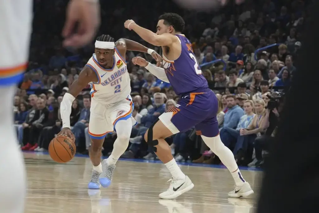 Shai Gilgeous-Alexander dribbles past Tuys Jones