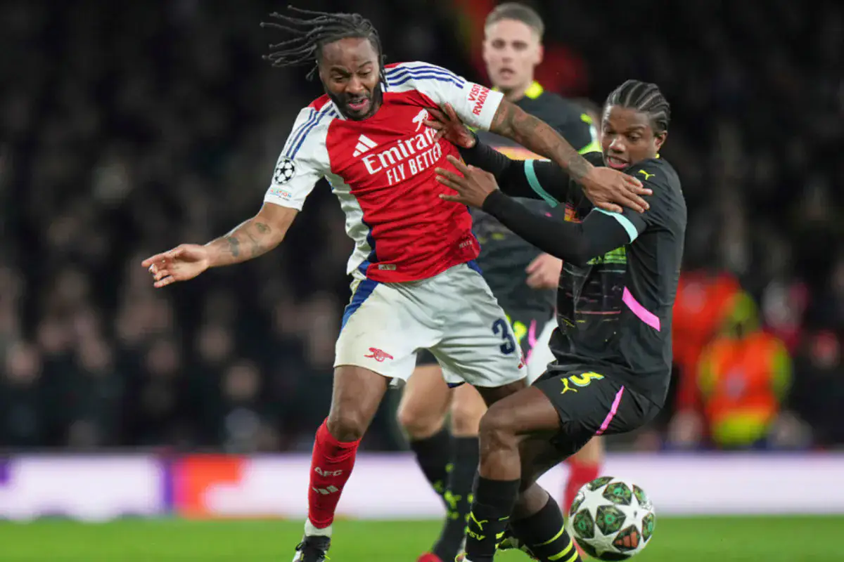 Raheem Sterling battling for the ball with a PSV player