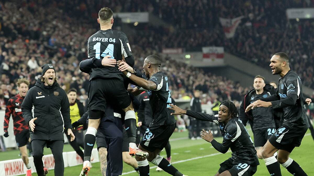 Bayer Leverkusen players celebrate after scoring a stoppage time winner against Stuttgart