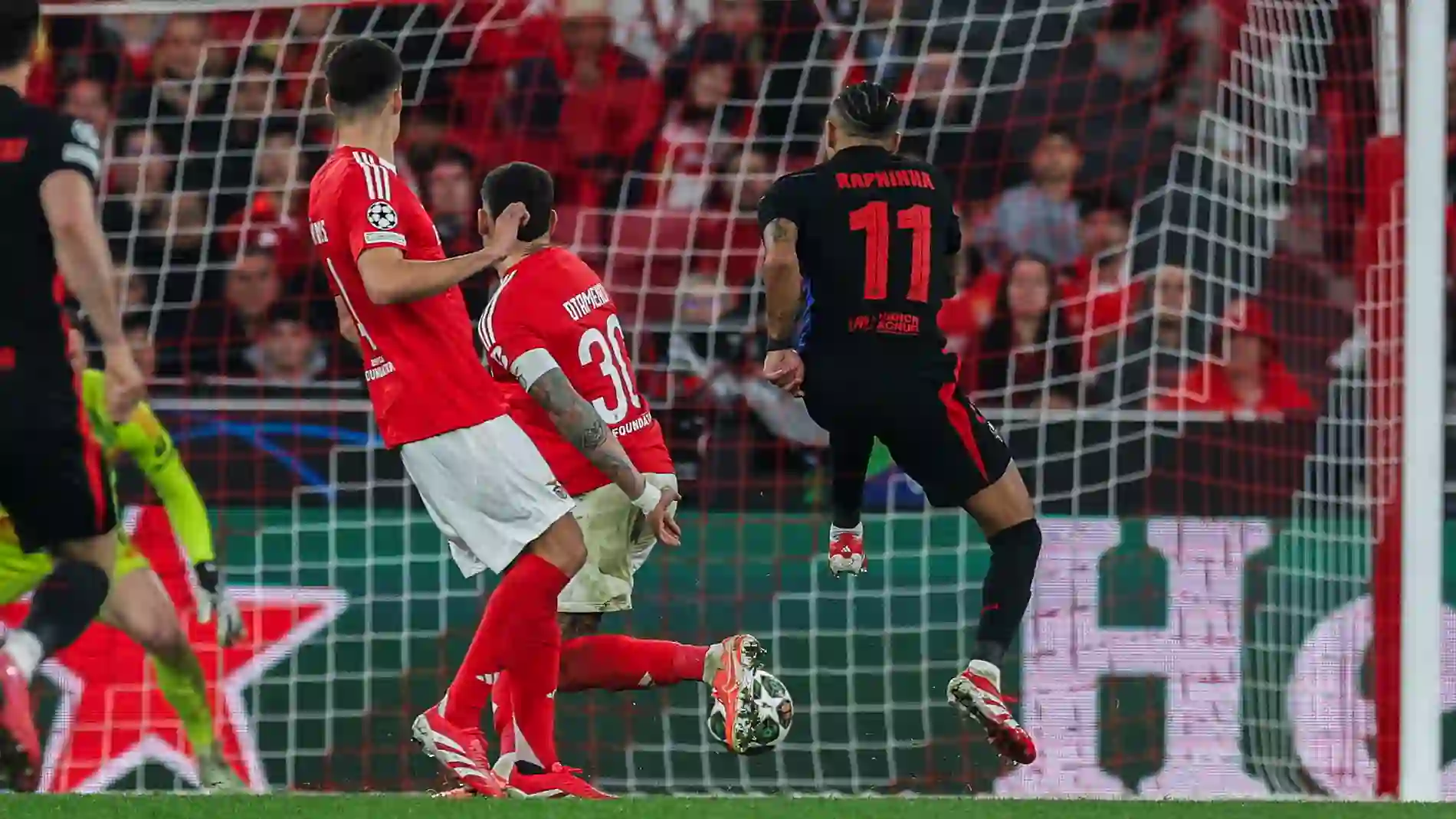 Barcelona's Raphinha shoots towards Benfica's net