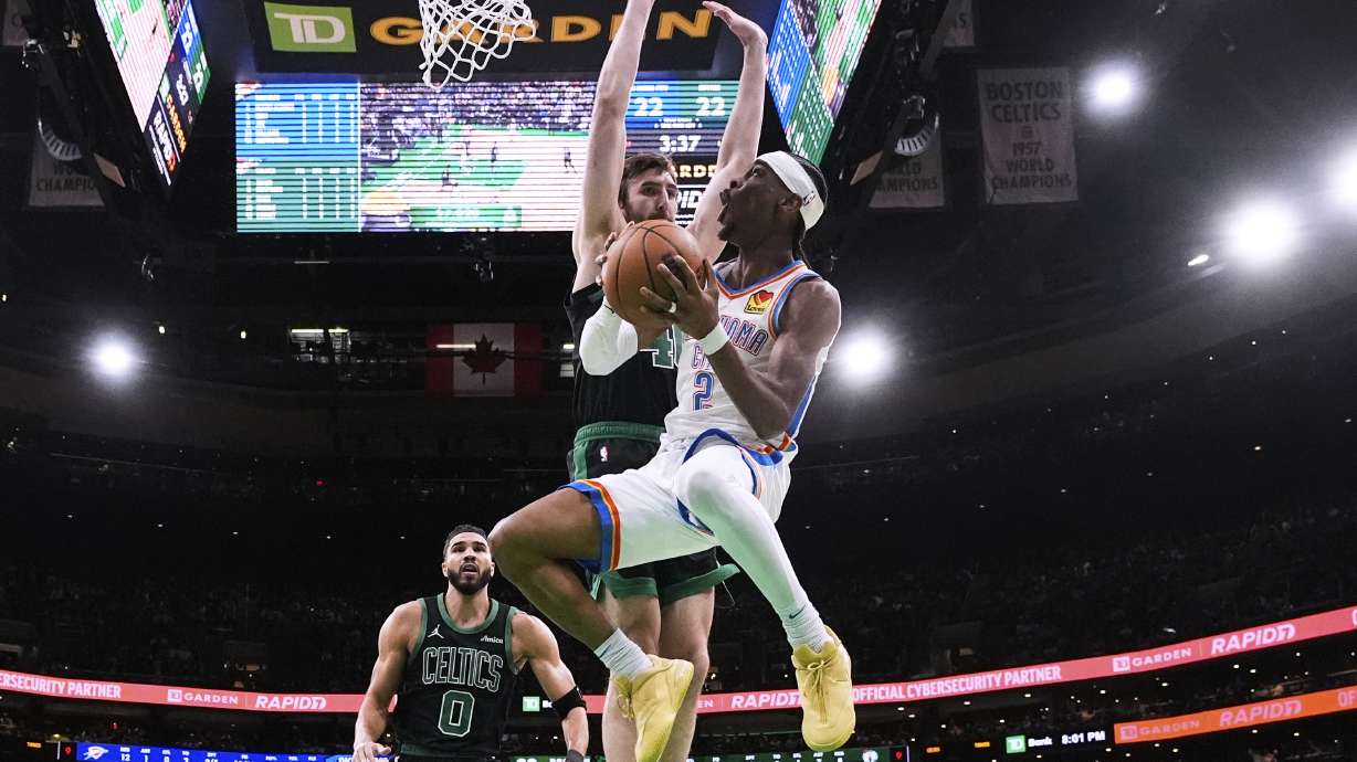 Shai Gilgeous-Alexander scoring in front of Jayson Tatum