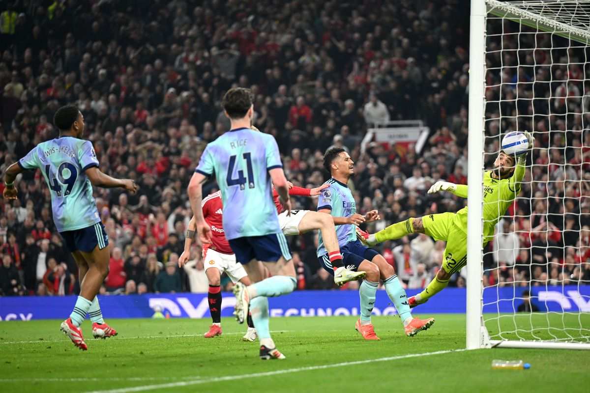 Arsenal's goalkeeper blocks a shot from Manchester United player