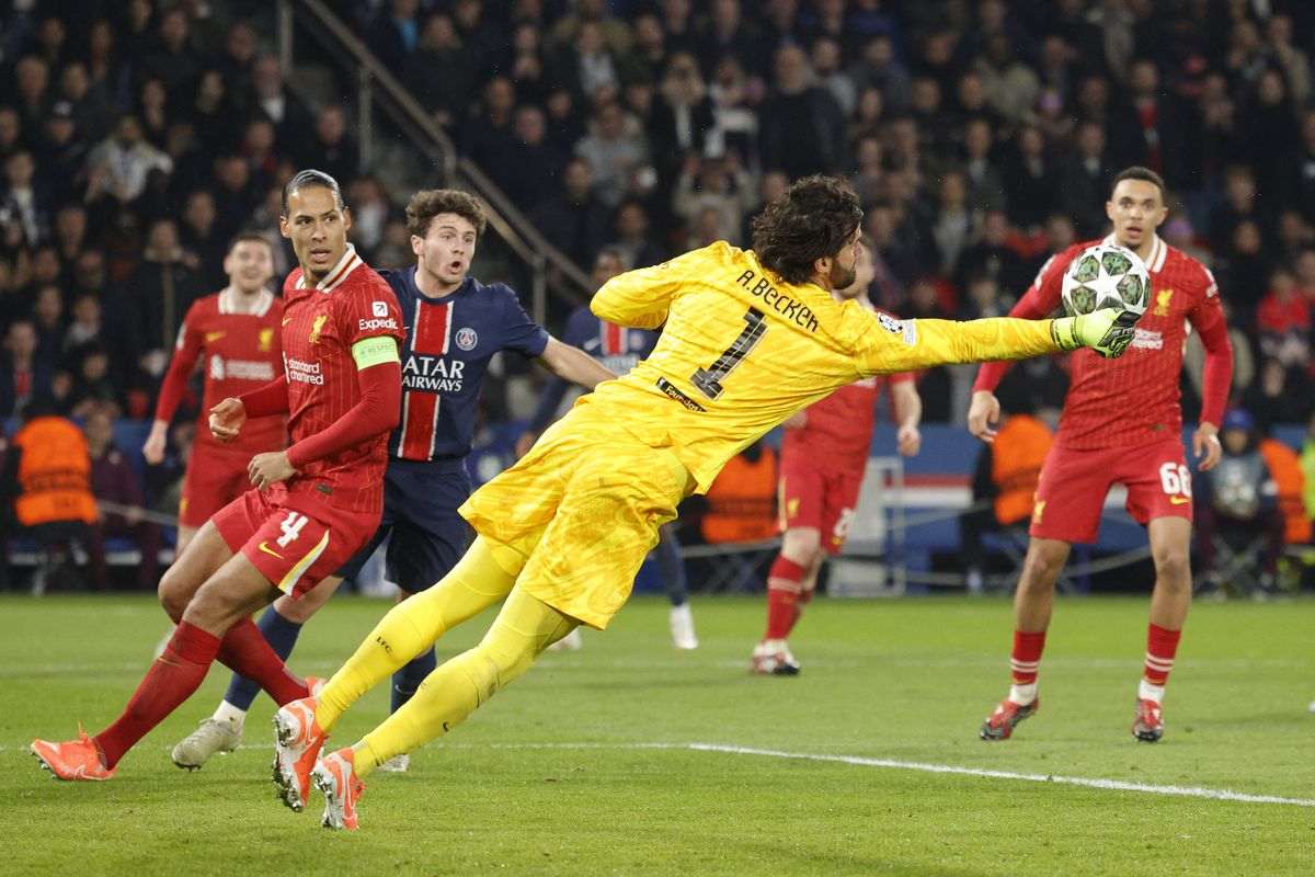 Liverpool's goalkeeper Alisson saves a shot from a PSG player